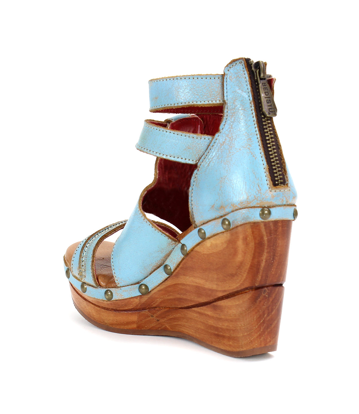 A sustainable wooden wedge sandal with woven strappy uppers in a lovely shade of blue, fit for the Bed Stu Princess.