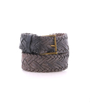 The Bed Stu Proem is a brown handwoven leather belt featuring a vintage metal buckle, showcased against a white background—ideal for adding rustic casual style to any outfit.