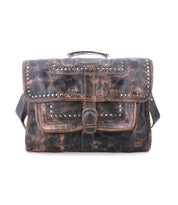 The Bed Stu Pub is a distressed brown leather satchel featuring studded details, a sturdy metal buckle, top handle, and adjustable shoulder strap. Its stylish and functional design is showcased against a white background.