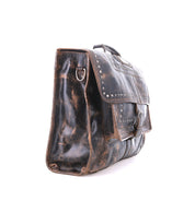 The Bed Stu Pub is a worn black leather briefcase satchel with stylish metal studs, a sturdy metal buckle on the front flap, and a handle, shown against a white background.