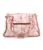 The Rockababy by Bed Stu is a light brown leather handbag featuring dual handles, a front zipper pocket, decorative stitching, and a detachable crossbody strap for versatile wear.