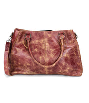 A distressed brown leather Bed Stu Rockaway handbag with double handles, a detachable shoulder strap, and a zip-pocket divider is displayed against a white background.