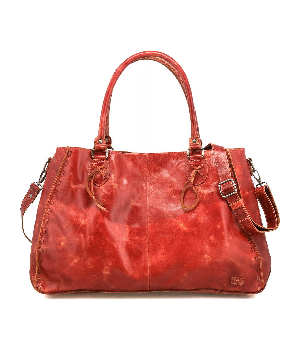 The Bed Stu Rockaway is a spacious, reddish-brown leather handbag featuring dual handles, side lacing, an adjustable shoulder strap, and a zip-pocket divider for organization.