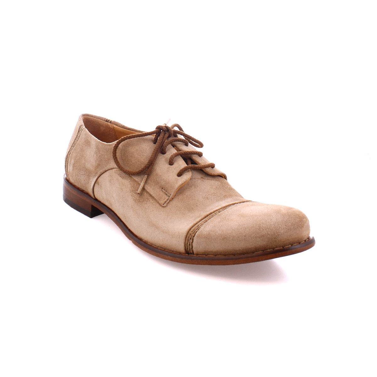 A light brown suede lace-up dress shoe with a rounded toe and dark brown sole viewed from the side, featuring a high-quality suede upper, the Sandstorm by Bed Stu.