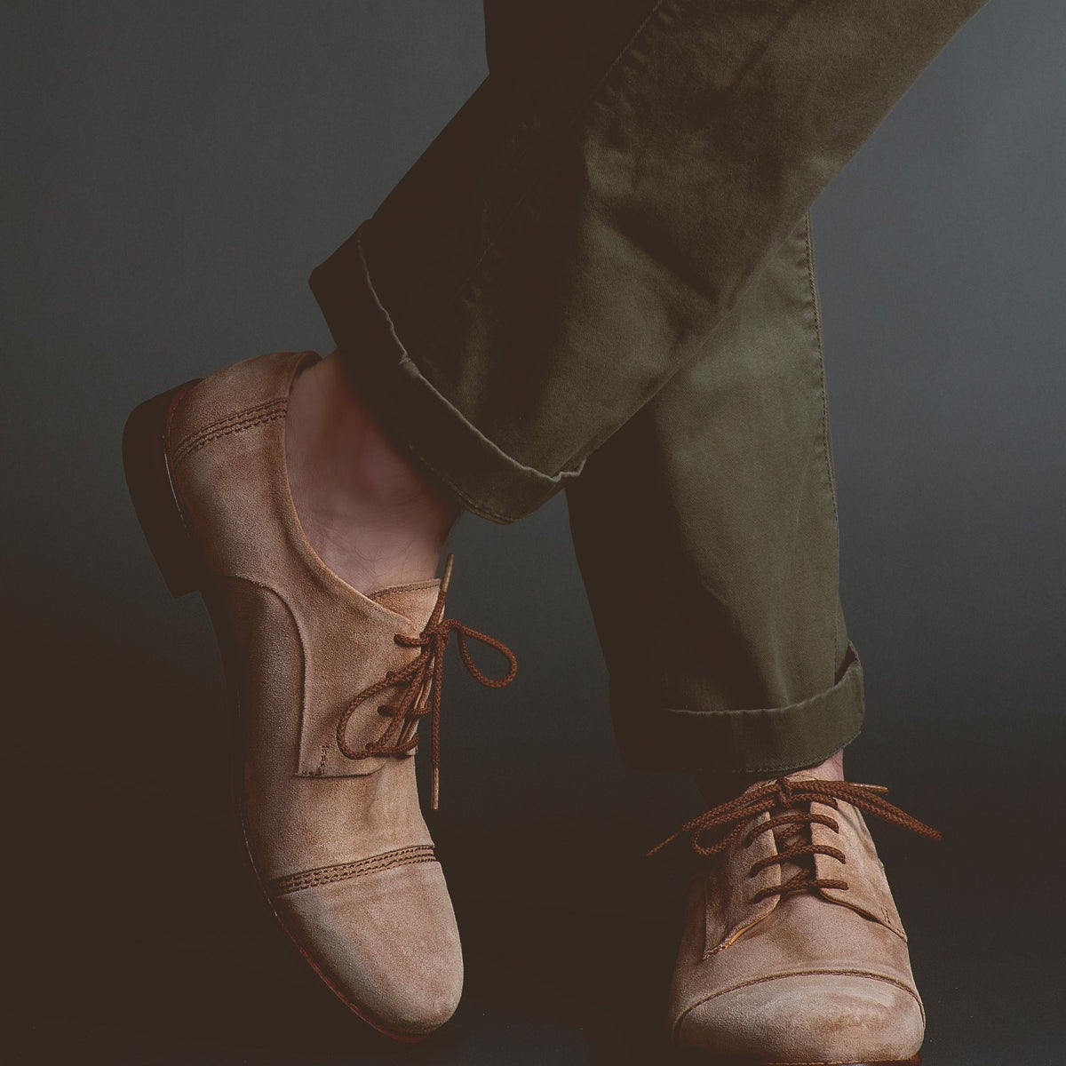 Person wearing Bed Stu Sandstorm tan vegetable-tanned leather lace-up shoes and olive green trousers.