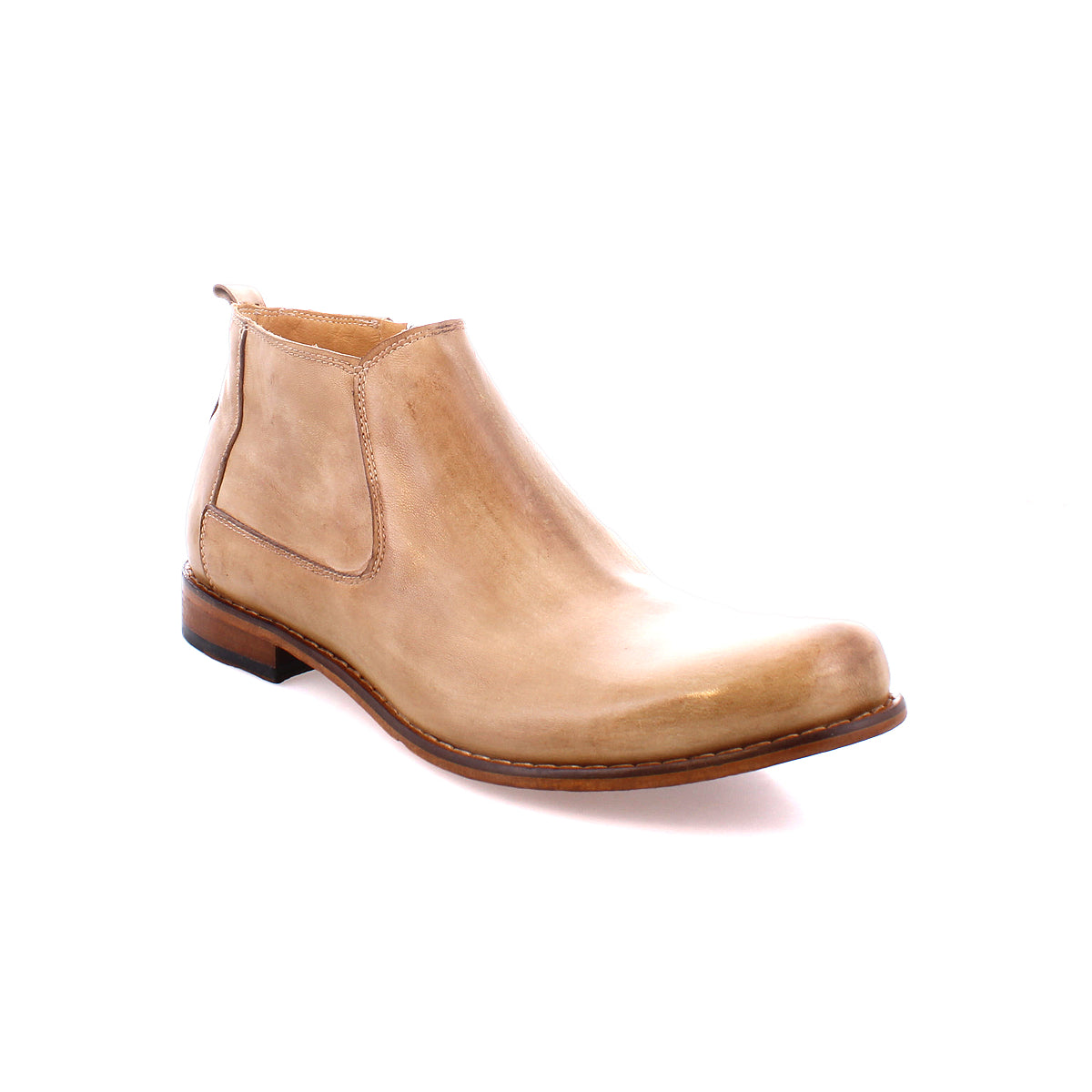 A tan Chelsea boot made from vegetable-tanned leather, featuring a low heel and a sleek design, showcases artisanal craftsmanship. This is the Seek by Bed Stu.