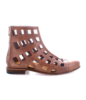Side view of a brown, cut-out Bed Stu Skyline ankle boot with multiple square openings and a back zipper, showcasing the quality of handcrafted Italy.