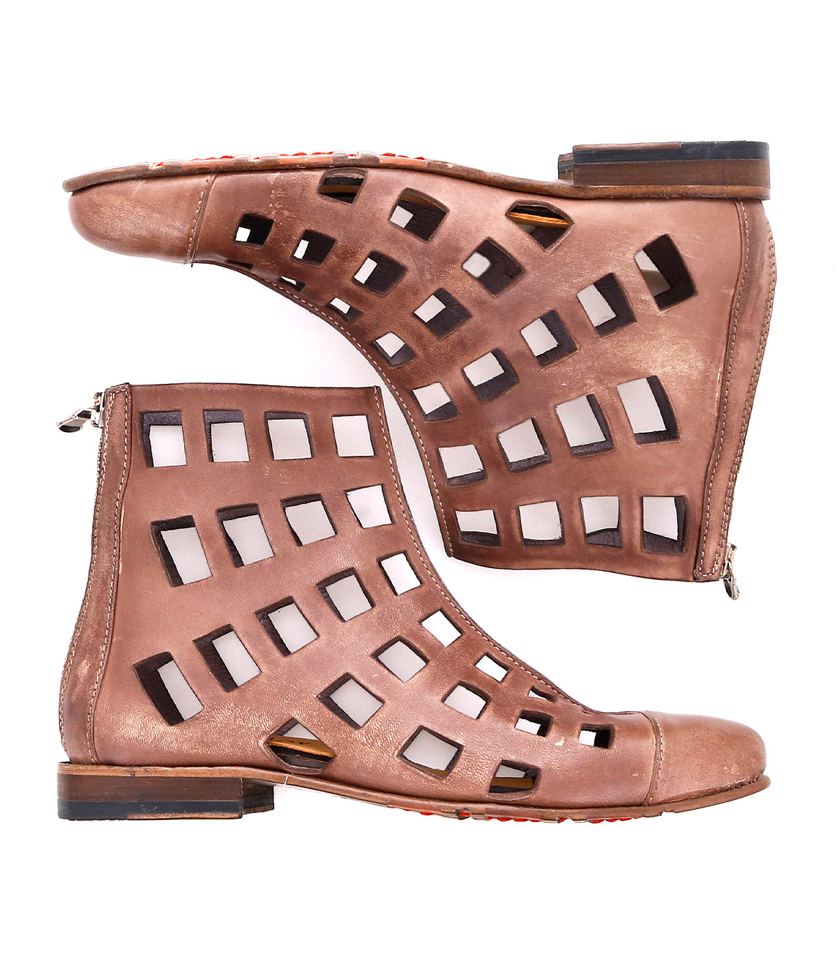 A pair of versatile short boots with square cut-out patterns and side zippers, displayed from a side view against a white background. These Skyline ankle boots by Bed Stu are perfect for any occasion.