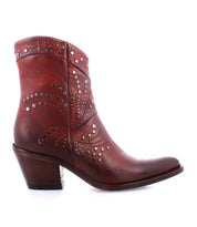 The Sposa by Bed Stu is a brown leather ankle bootie featuring decorative metal studs and a low heel, crafted from vegetable-tanned leather, shown from the side on a white background.