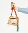A person showcasing their personal expression through an accessory - a bag adorned with a stylish Bed Stu Tassel Clip.