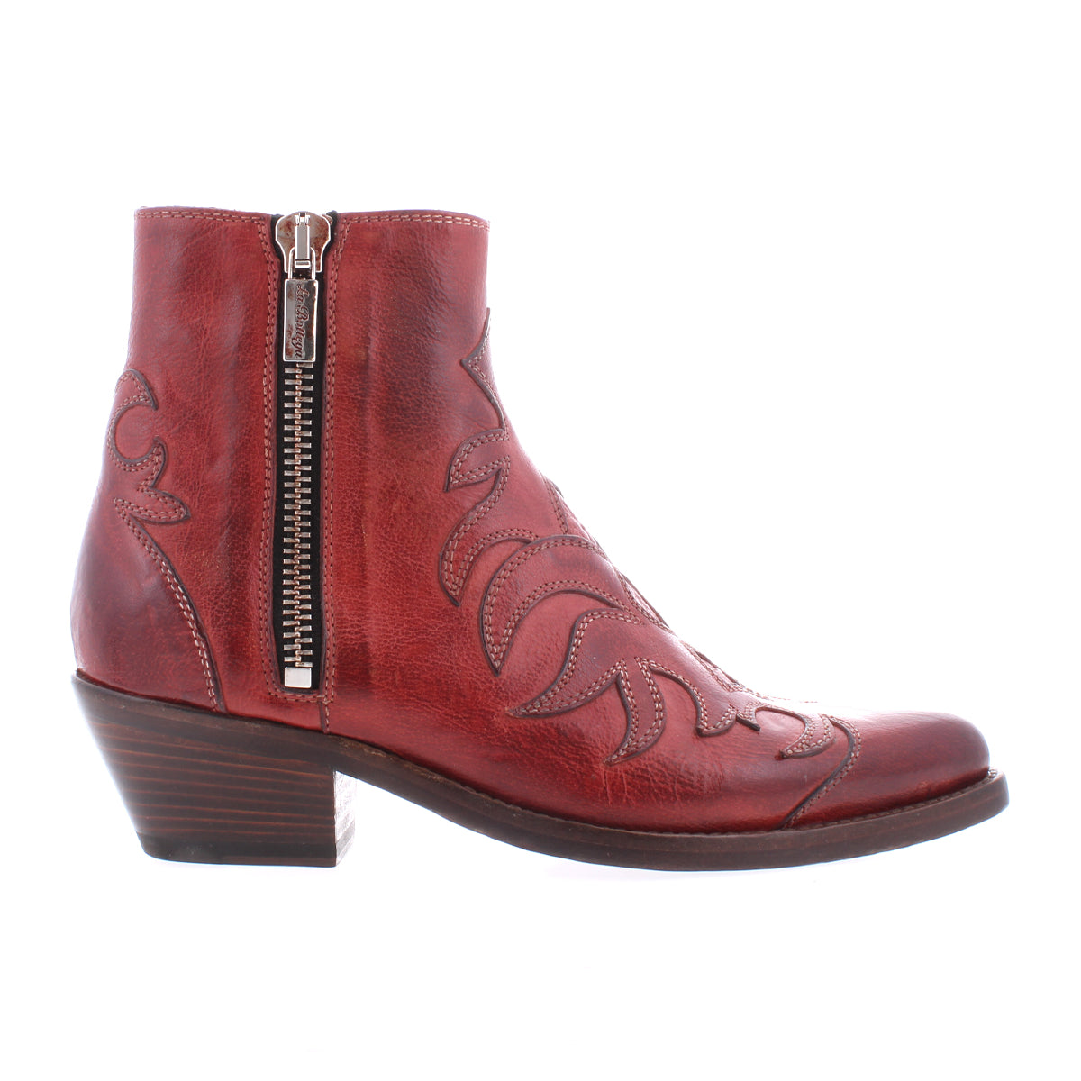 The Bed Stu Tentativa is a red leather ankle boot featuring artisan detail, decorative stitching, a side zipper, and a low stacked heel, displayed in profile on a white background.