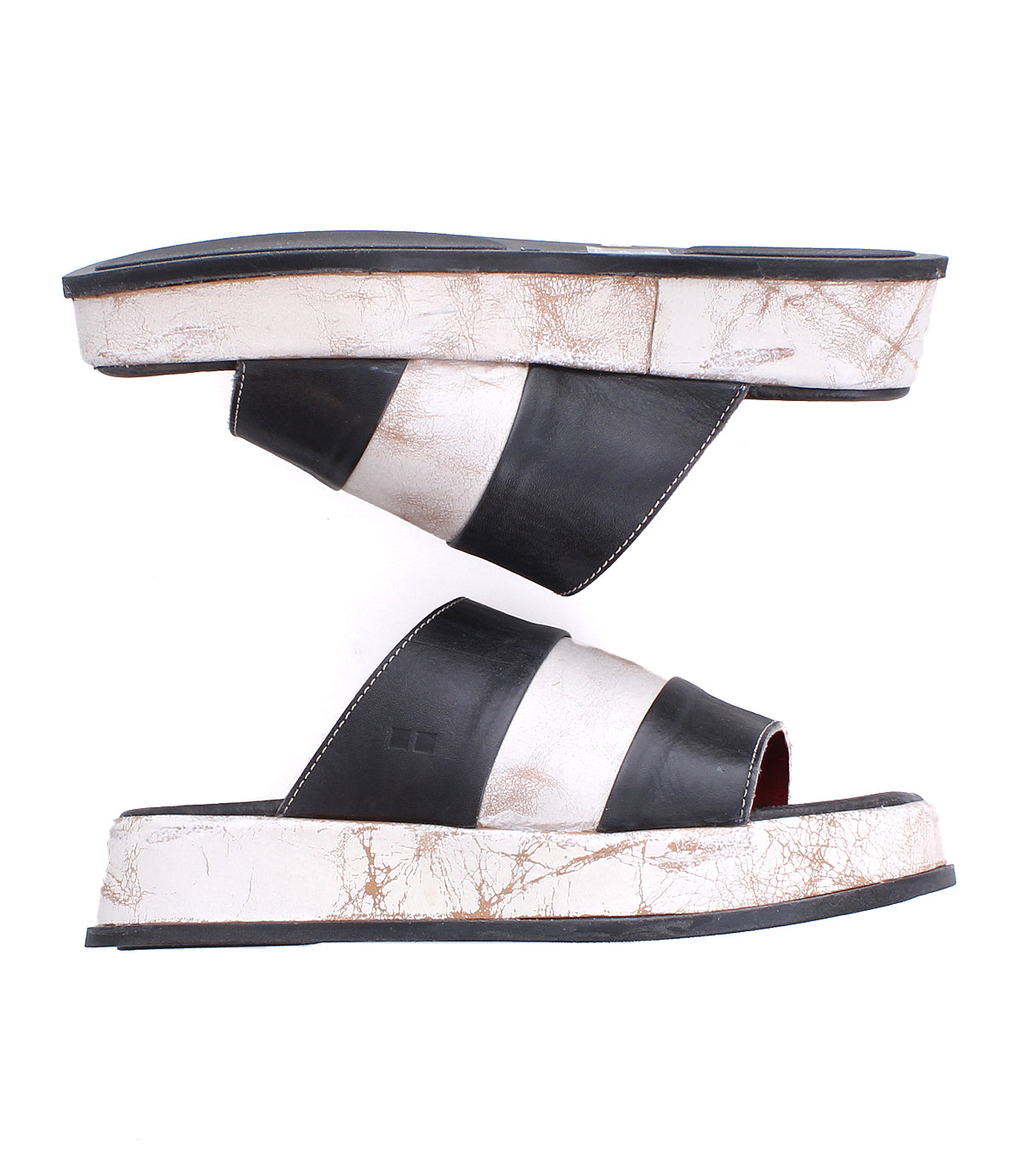 The Bed Stu Vext sandals are black and white platform slides featuring wide horizontal stripes and unique colors, with visible wear marks on the leather-wrapped sole and sides.
