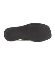 The image displays the black rubber sole of the Bed Stu Vext platform slide sandal viewed from below, highlighting textured grip areas at the heel and ball of foot.