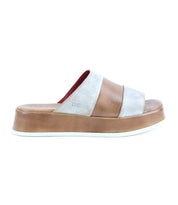 The Bed Stu Vext is a brown and beige platform slide sandal with bold color blocking, wide straps, and a thick leather-wrapped sole, shown from the side against a white background.