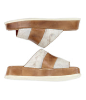 The Bed Stu Vext platform slide sandals feature thick tan and white crossover straps and a leather-wrapped sole, shown in a side view.