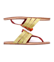 The Yoli sandals from Bed Stu feature brown leather soles with vibrant yellow and red leather straps. Positioned artfully against a white background, these stylish sandals ensure comfort with their cushioned insoles.