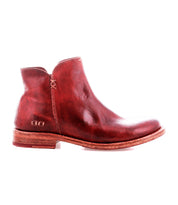 The Bed Stu Yurisa is a red leather ankle boot with a low heel, visible stitching, and a sturdy Vibram outsole—shown in profile on a white background—for the perfect everyday style.
