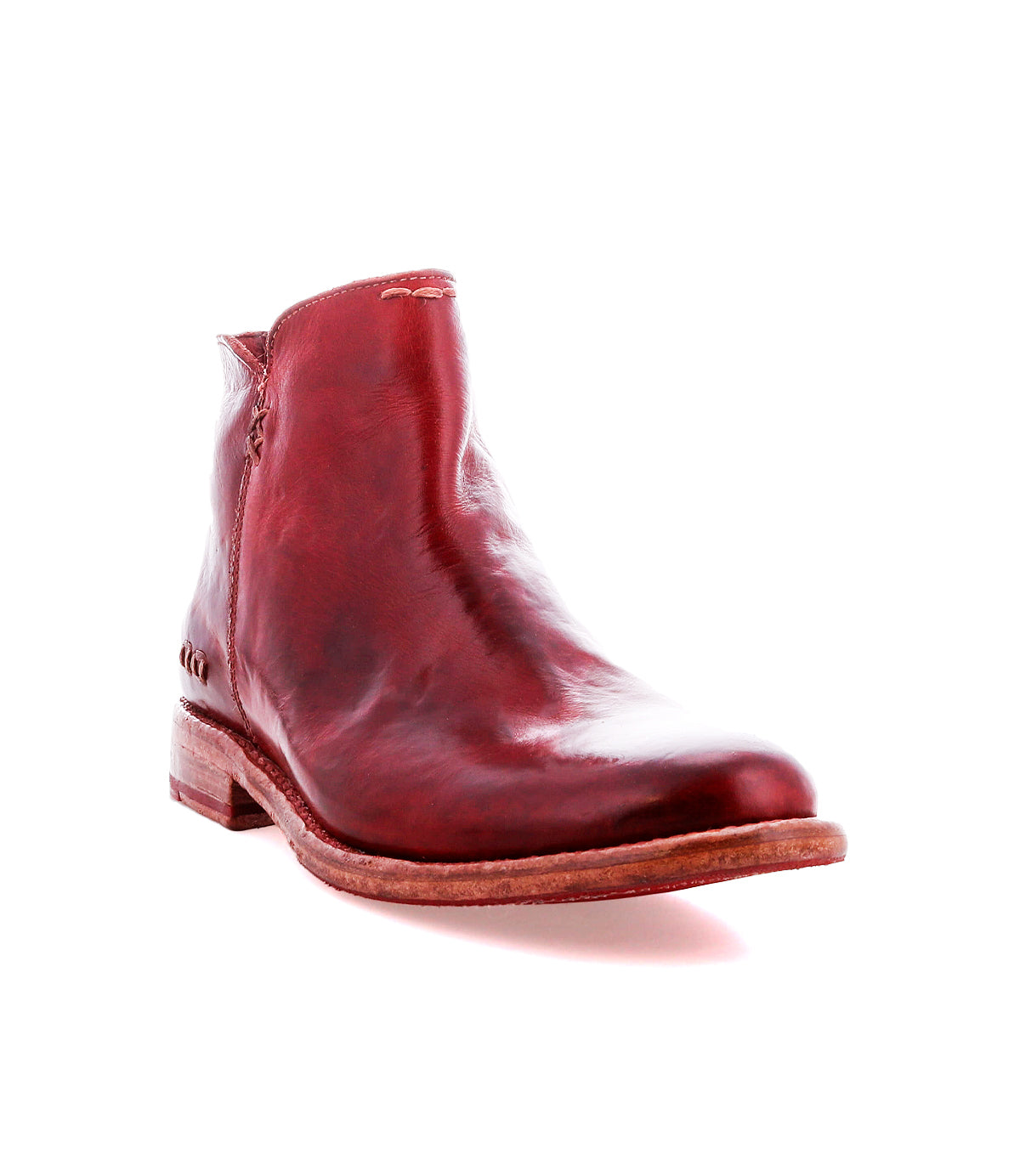 The Bed Stu Yurisa is a red leather ankle boot with a low wooden heel and red leather lining, designed for everyday wear, shown against a white background.