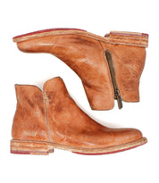 The Yurisa ankle boots by Bed Stu feature brown worn leather, side zippers, stacked wooden heels, and a durable Vibram outsole, shown side by side on a white background.