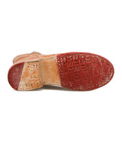 The Yurisa by Bed Stu is a brown leather everyday boot shown from the sole, featuring a red textured Vibram outsole and noticeable signs of wear.