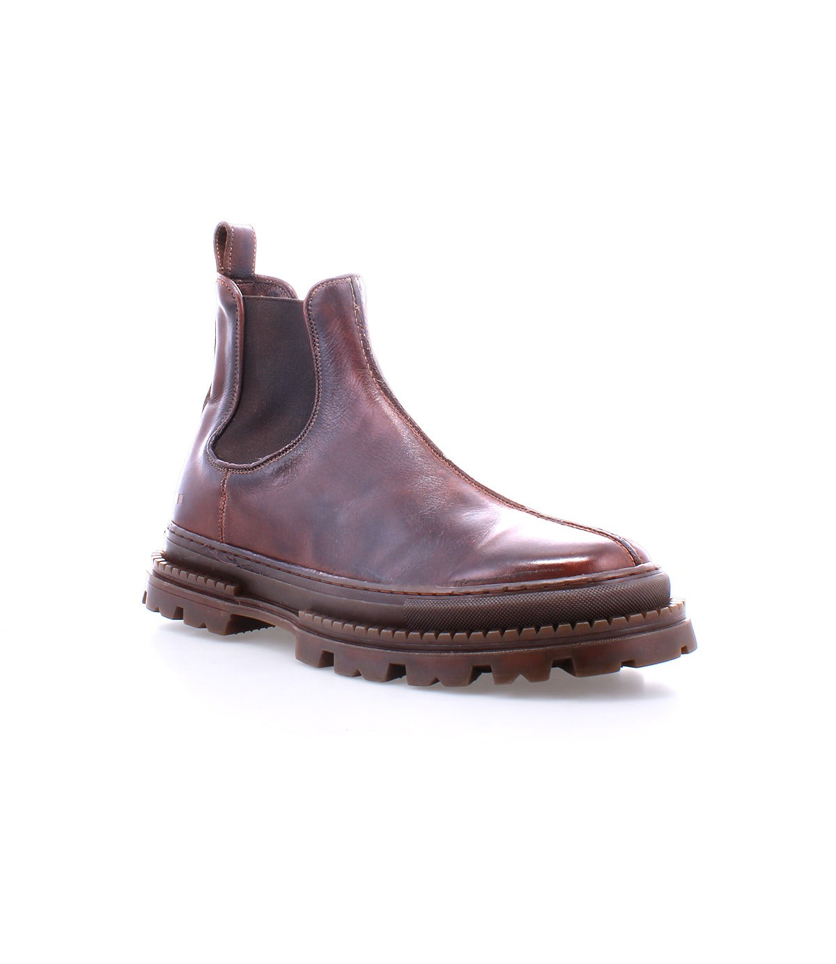 The Bed Stu Accelerate is a brown leather Chelsea boot featuring elastic side panels and a rugged lug outsole, shown against a white background.