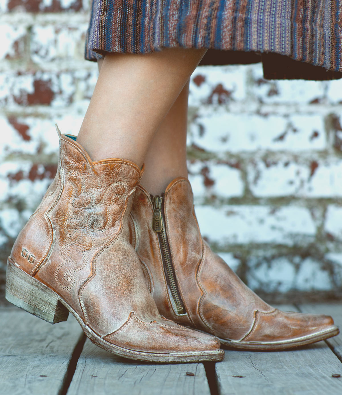 A woman donning a stylish pair of Bed Stu Ace leather cowboy boots.