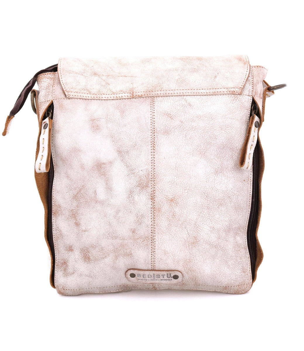 A light beige Bed Stu Ainhoa LTC crossbody handbag with distressed finish and dark brown accents, isolated on a white background.