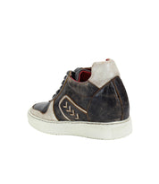 A single worn, brown and beige high-top Andromeda sneaker by Bed Stu, laced up and viewed from the back. The street-smart design hints at a hidden heel that adds both height and style.