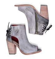 A pair of Angelique grey leather ankle boots with a zipper, by Bed Stu.