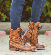 A woman's legs standing in a pair of Bed Stu Anne boots.