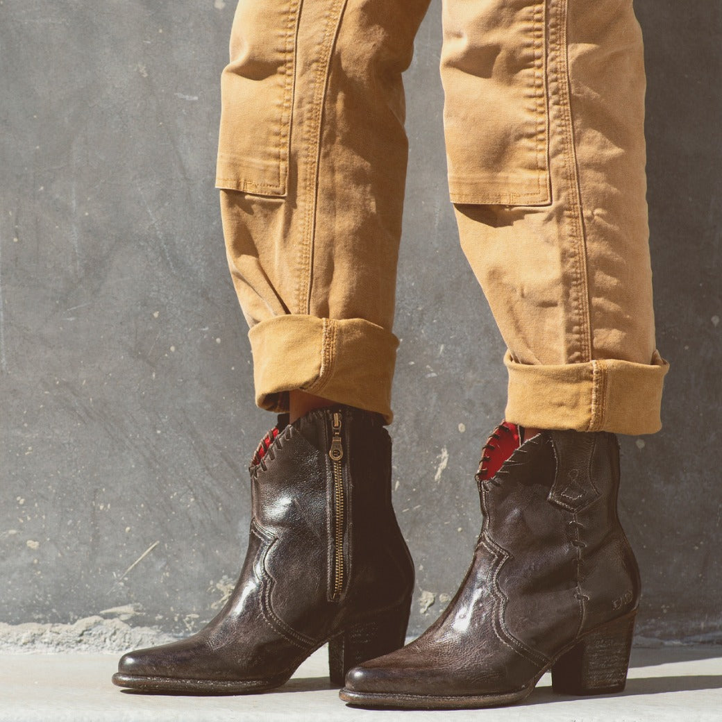A woman wearing Bed Stu Baila II boots and a pair of khaki pants.