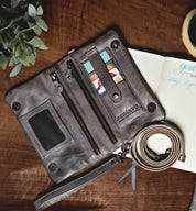 A Bed Stu Bayshore leather wallet on a table next to a notebook.