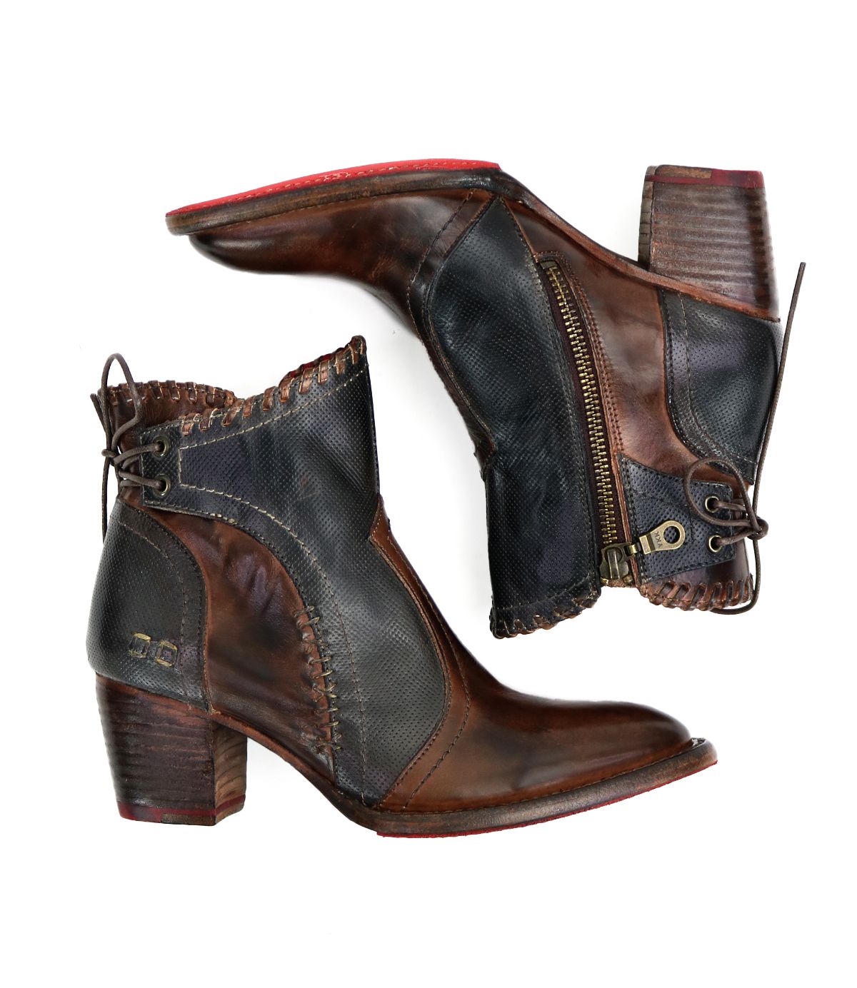 A pair of Bed Stu Bia handcrafted brown leather booties, featuring stacked heels, side zippers, and decorative stitching, positioned on a white background.