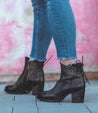 A woman wearing Bia jeans and Bed Stu black ankle boots.