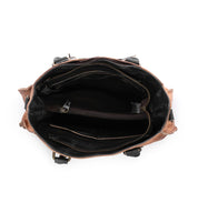 Inside of a tan Bed Stu Bruna leather bag with black handles.