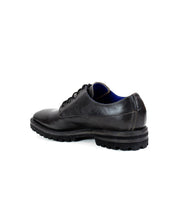 A single black leather men's oxford shoe named Carter by Bed Stu, featuring a rugged rubber sole and Goodyear welt construction, viewed from the back and side.