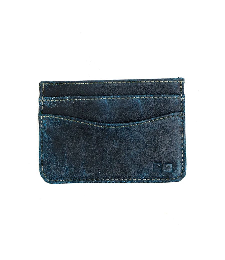The Chuck by Bed Stu is a worn, dark blue leather card wallet featuring multiple card slots and visible stitching. Presented on a white background, it offers a compact and convenient solution for your everyday essentials.