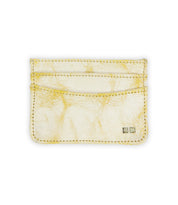 The Chuck by Bed Stu is a compact cardholder with a cracked gold finish, featuring two card slots and two metallic square embellishments in the lower right corner.