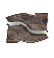 A pair of Bed Stu Clyde men's brown leather chukka boots on a white background.