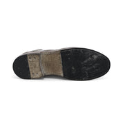 A pair of Clyde shoes with a black sole on a white background by Bed Stu.