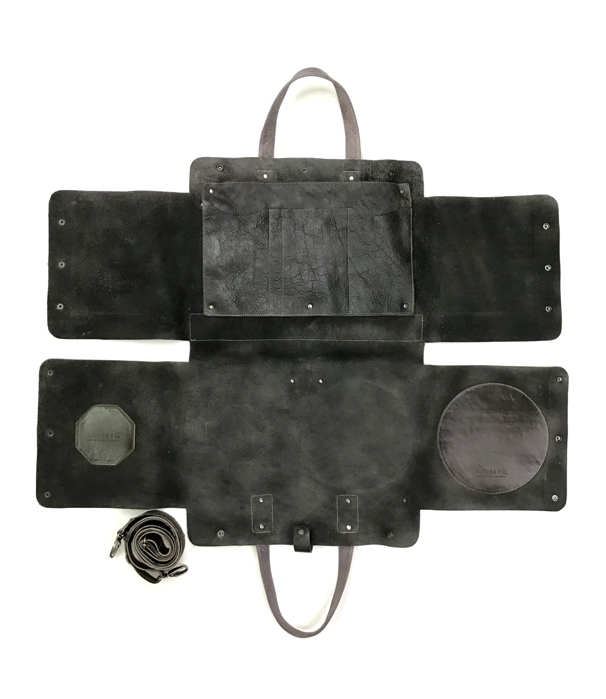 A Bed Stu Commuter, a multifunctional black leather bag with two compartments, perfect for commuters. Comes with a key ring and can accommodate laptops up to 15 inches.