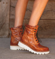 A woman's legs in a pair of Bed Stu Elisha II brown leather boots.