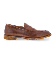 The Envoy loafer by Bed Stu, featuring a brown leather exterior with a penny strap detail and a contrasting rubber sole, showcases Italian elegance against a white background.