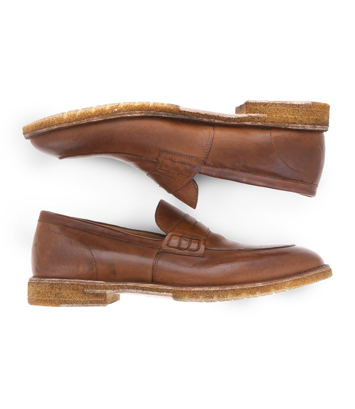 A side view of the Bed Stu Envoy loafers, featuring thick, textured soles and premium Italian leather craftsmanship, showcases one shoe placed above the other to highlight their elegant brown design.