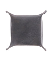 A small, square leather catchall tray with raised corners, perfect for holding loose change and keys, viewed from above. Introducing the Expanse Catchall Tray by Bed Stu.