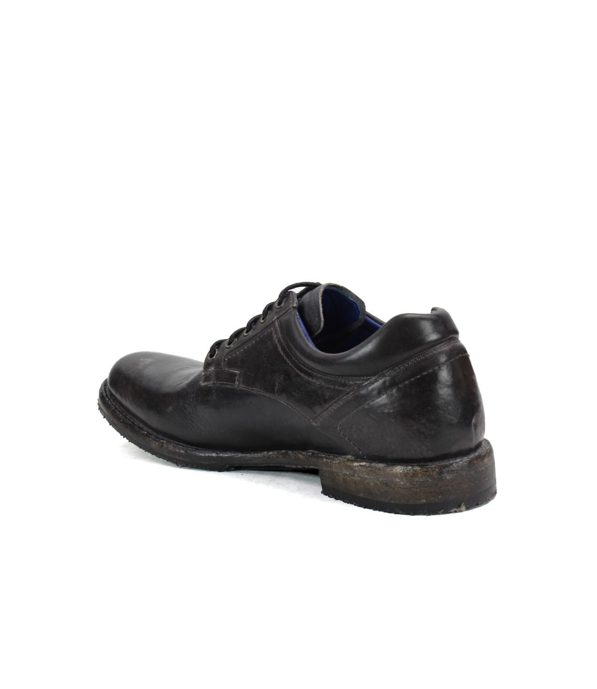The Bed Stu Fierce men's derby shoe in black leather shows visible wear on the sole from an angled back view, highlighting its classic design with a modern touch.