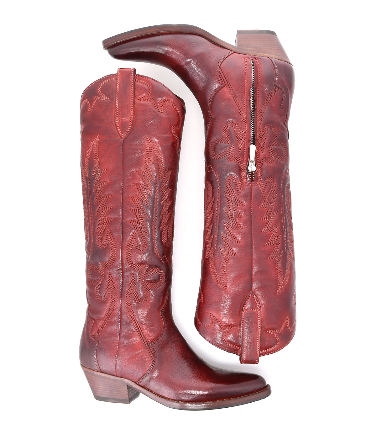 A pair of red leather Finito cowboy boots with a distressed finish, set against a white background, by Bed Stu.