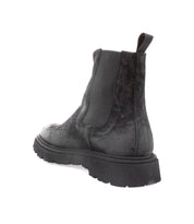 A black Grit Chelsea boot showcasing enduring quality on a white background, by Bed Stu.