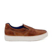 A men's brown slip on sneaker with a white sole called Harry by Bed Stu.