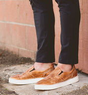 A man wearing a pair of Harry slip on sneakers by Bed Stu.